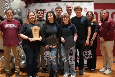 Members of Princeton Senior High School's Academic Showdown team holding a trophy.