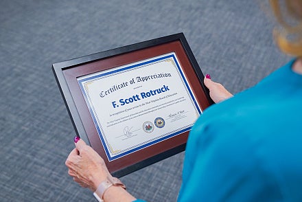A certificate in a frame addressed to F. Scott Rotruck. 