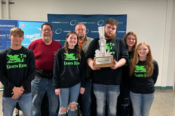 Students at the November 14, 2023 MCTEC event showing off their trophy.