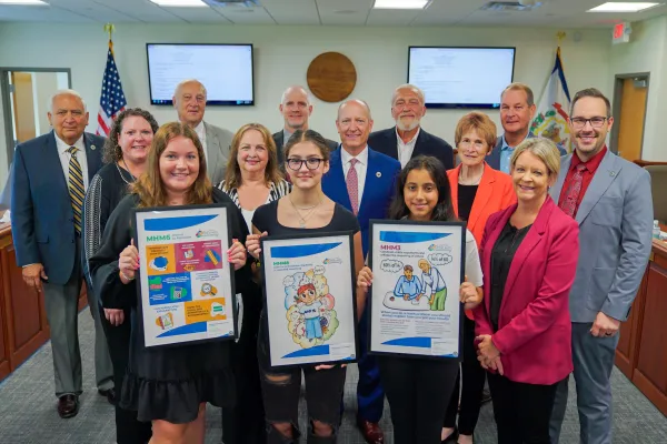 Pictured are students holding posters and posing for a photo with members of the West Virginia Board of Education 