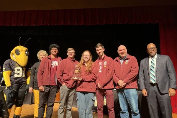 Pictured are students holding a first place trophy.