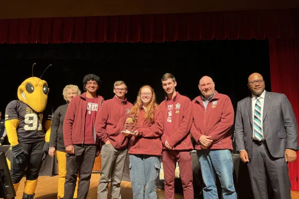 Pictured are students holding a first place trophy.