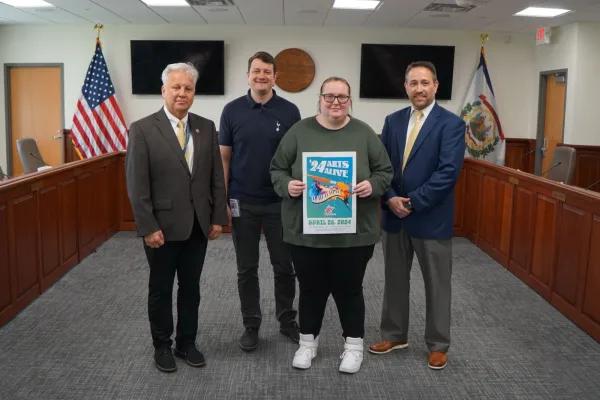 (L-R): PK-12 Academic Support Coordinator Timothy James, Communications Program Specialist Tom Pickens, Robert C. Byrd High School Senior Alexis Brewer and Assistant Superintendent of PK-12 Adult Instruction and Career Engagement Clinton Burch pose for a photo with the 2024 Arts Alive poster.