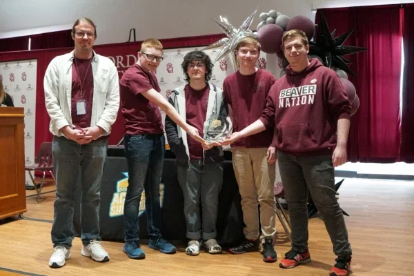 Bluefield High School students posing with a first-place trophy.