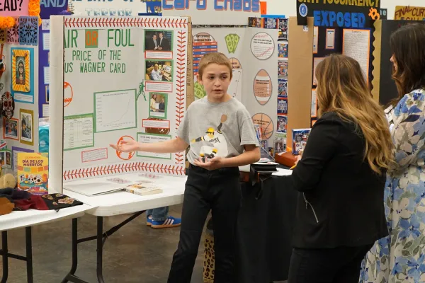 Student presenting his project to judges.