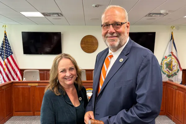 Nancy White and Paul Hardesty holding a meeting gavel.
