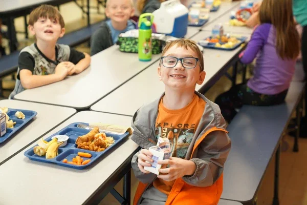 Students eating lunch in a school cafeteria.
