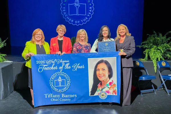 Five people holding a banner. 2026 West Virginia Teacher of the Year Tiffany Barnes.
