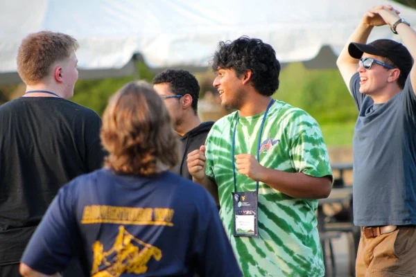 People smiling and standing together in a group.