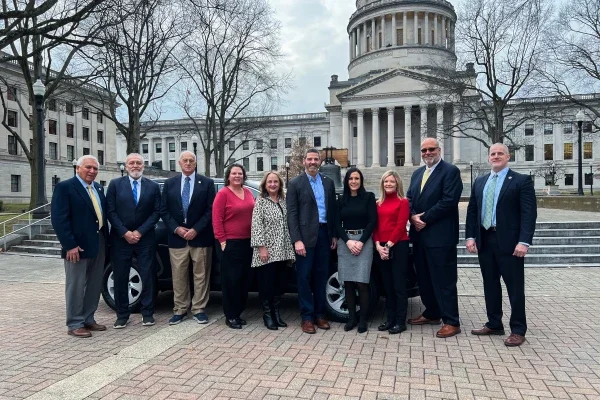 David Rosier, Tiffany Barnes, and West Virginia Board of Education members smiling while standing in front of a Toyota RAV4.