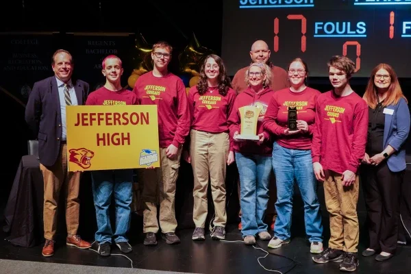 Members of Jefferson High School's Academic Showdown team holding a trophy.