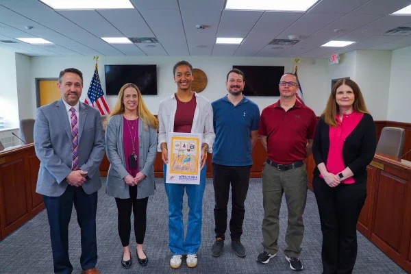 Assistant Superintendent Clinton Burch, Jennifer Stephens, Ayo Buerger, Tom Pickens, Will Garuccio, and Karen Linville smiling.