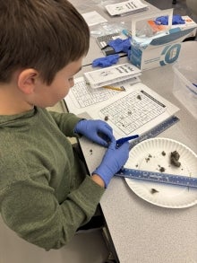 A student measuring something.