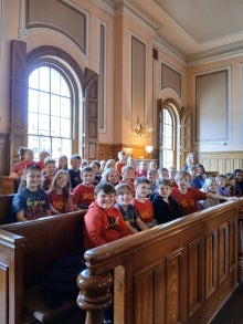 Students sitting in benchs.
