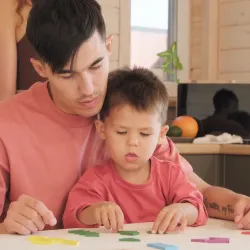 Parent helping child learn