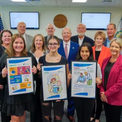Pictured are students holding posters and posing for a photo with members of the West Virginia Board of Education 