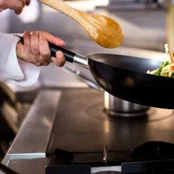 Chef cooking at industrial grill