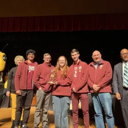 Pictured are students holding a first place trophy.