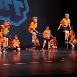Students performing exercise routines on stage.
