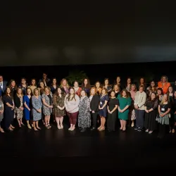 National Board Certification honorees standing together on stage at 2025 celebration