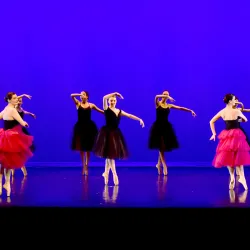 Students performing a performative dance routine on stage
