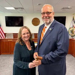 Nancy White and Paul Hardesty holding a meeting gavel.
