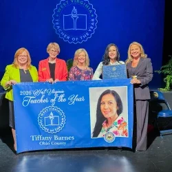 Five people holding a banner. 2026 West Virginia Teacher of the Year Tiffany Barnes.