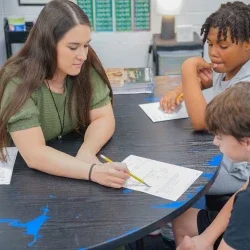 A teacher assisting a student.