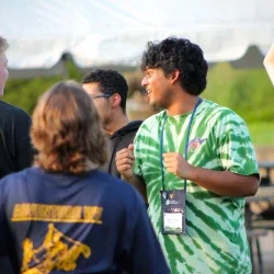 People smiling and standing together in a group.