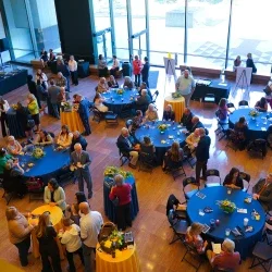 People sitting at tables enjoying refreshments at an award event