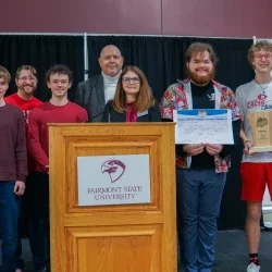 Members of Bridgeport High School's Academic Showdown team holding a trophy.