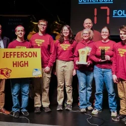 Members of Jefferson High School's Academic Showdown team holding a trophy.