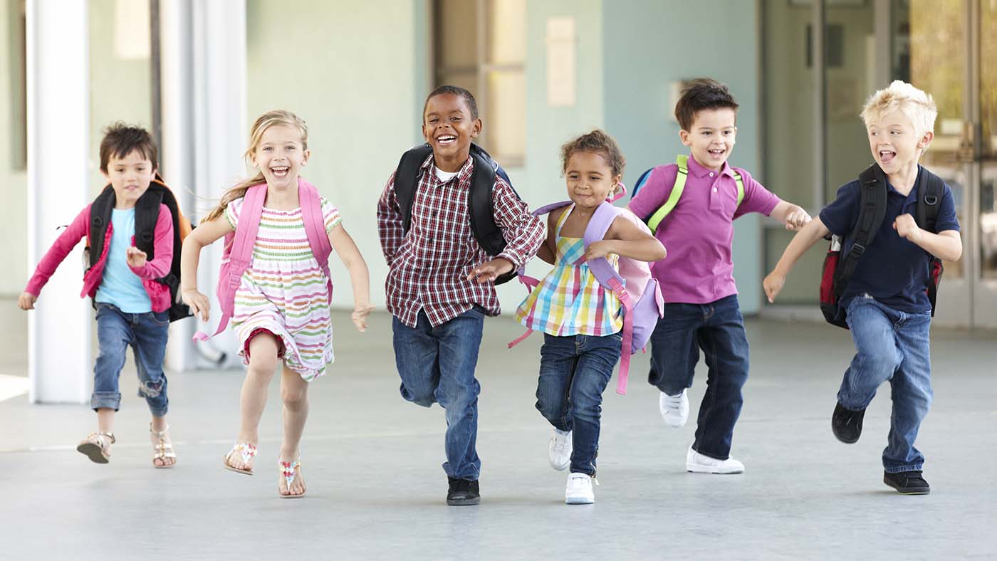 children running towards camera with smiles on their faces.
