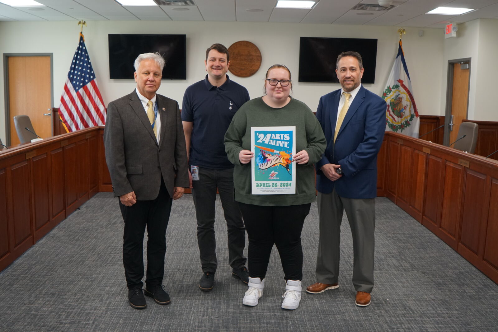 (L-R): PK-12 Academic Support Coordinator Timothy James, Communications Program Specialist Tom Pickens, Robert C. Byrd High School Senior Alexis Brewer and Assistant Superintendent of PK-12 Adult Instruction and Career Engagement Clinton Burch pose for a photo with the 2024 Arts Alive poster.