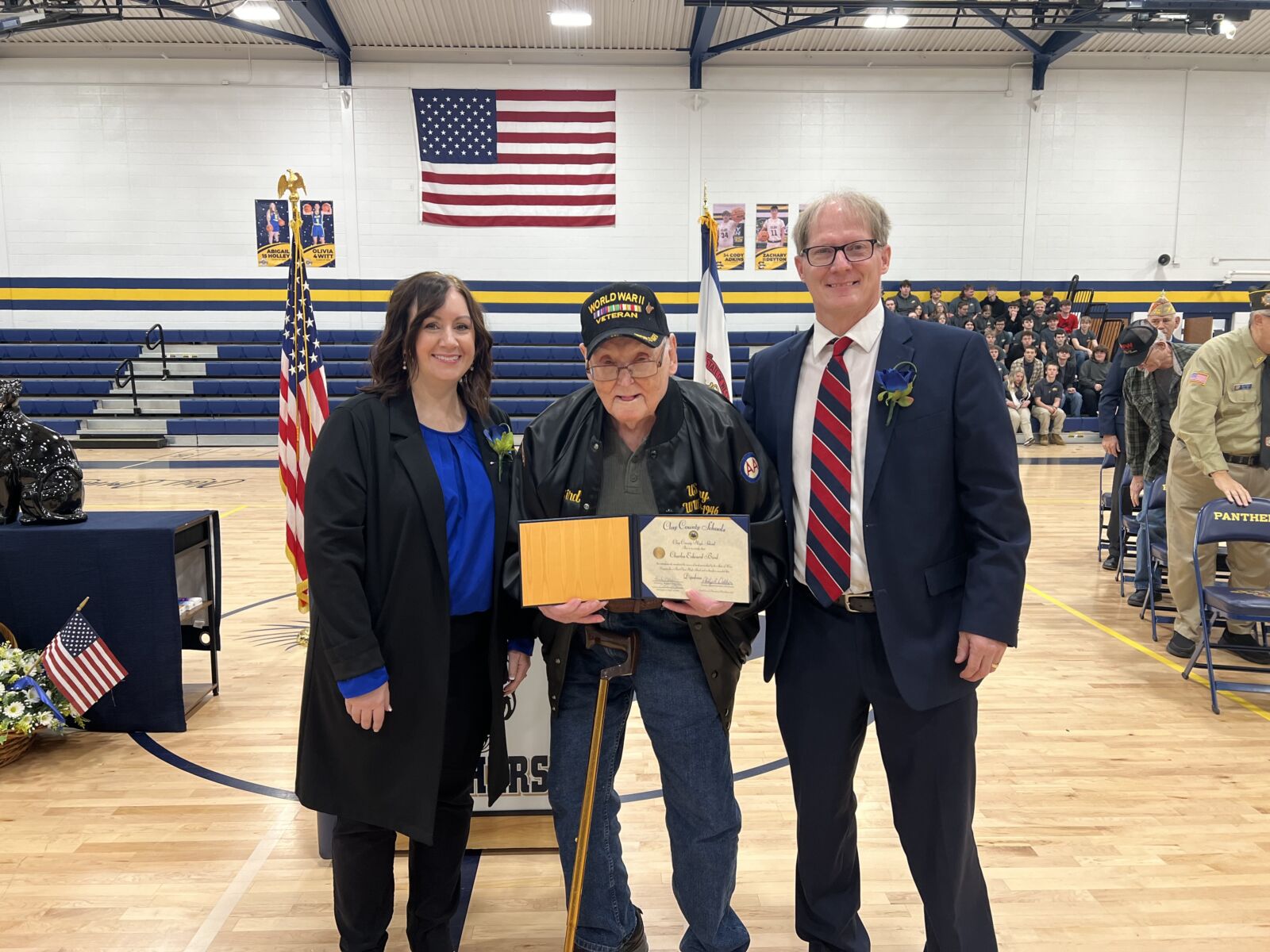 Clay County Board of Education President Phoebe Nichols, World War II Veteran Charles Bird and Clay County Superintendent Phil Dobbins pose for a photo with Bird’s high school diploma.