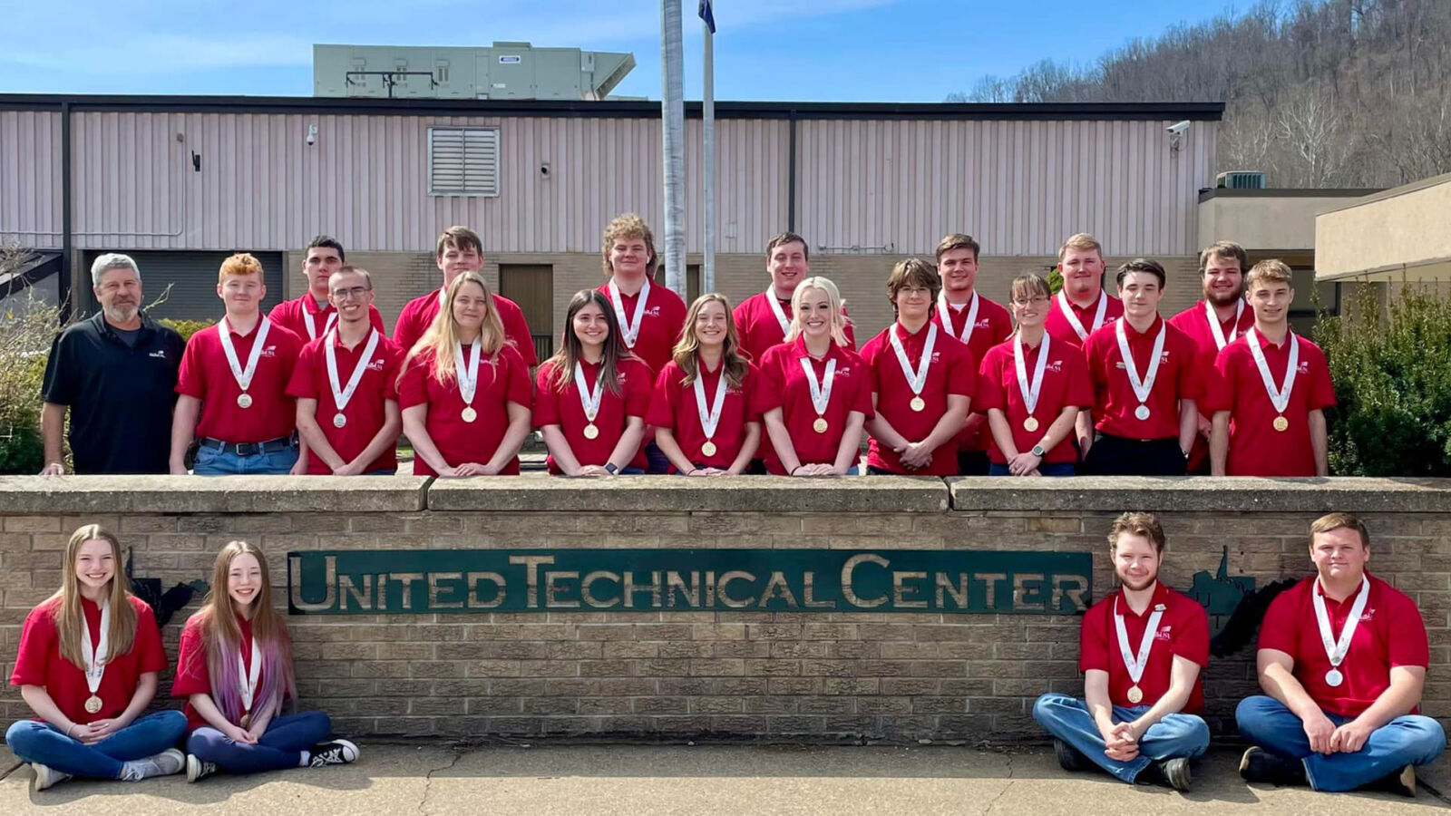 United Technical Center Student Group Photo, in front of UTC sign