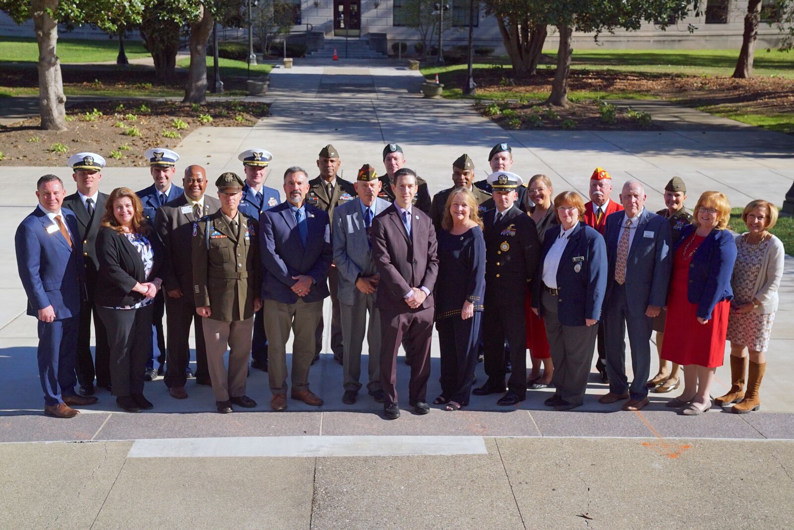 Pictured are people posing for a group photo.